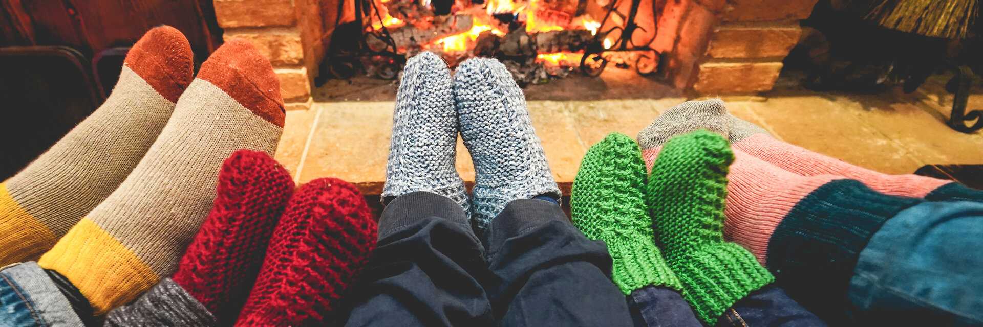 Family warming their feet by the fire in an Indianapolis home