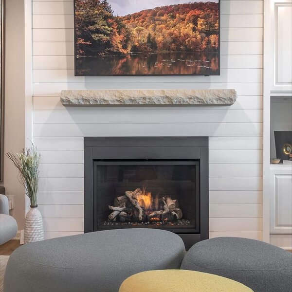After—modern shiplap accent wall with gas firebox, rough-hewn stone mantel beam, and TV alcove