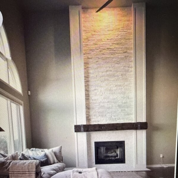 Inspiration—homeowner's phone screenshot of a tall vertical stone column with dark wood mantel